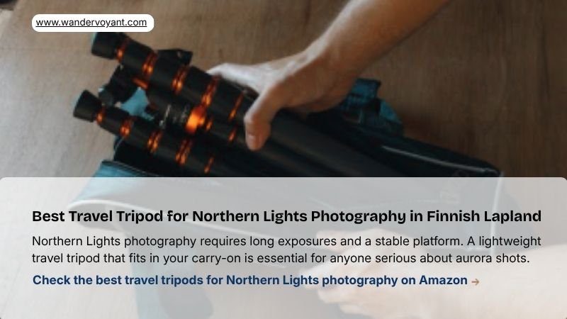 Compact travel tripod in snow clearing essential gear for long exposure Northern Lights photography in Finnish Lapland