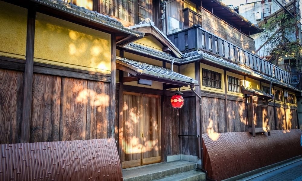 Gion district in Kyoto at night featuring lantern-lit Hanamikoji Street, traditional wooden teahouses, and geiko culture in a historic Japanese neighborhood.