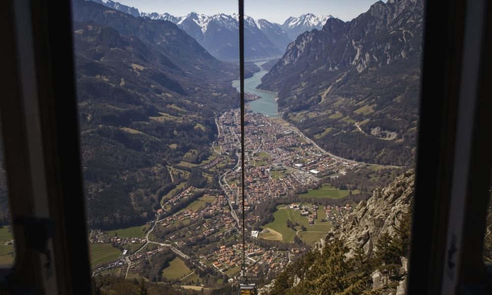 View from the Bolzano cable car funicolare over the valley, vineyards and Dolomite mountains, South Tyrol Italy