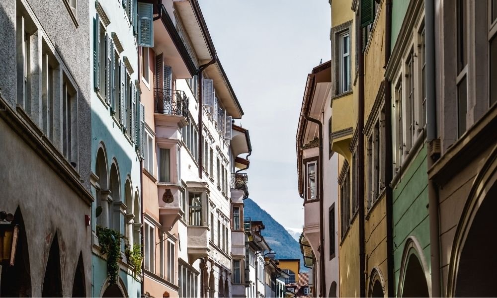 Arcaded Lauben streets of Bolzano old town with Dolomite mountains in the background, South Tyrol Italy