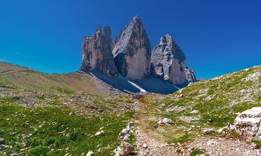 Tre Cime di Lavaredo three rock towers at golden hour in the Italian Dolomites, view from the hiking loop trail
