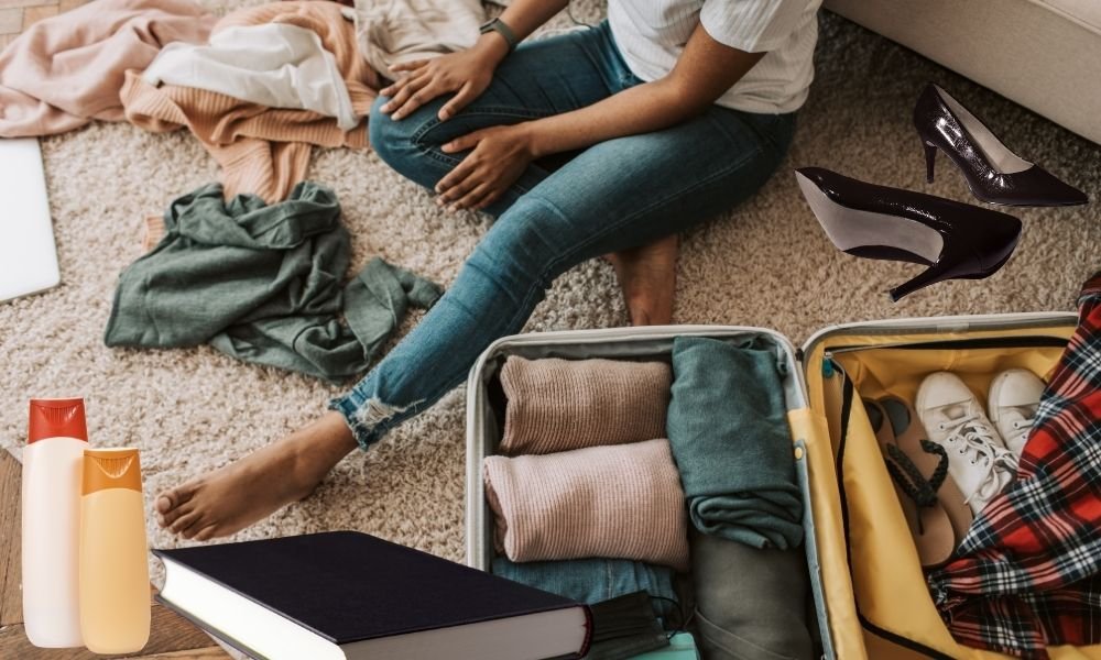 Flat lay of items to leave behind when packing for Scandinavia including heavy cotton clothing multiple pairs of shoes full-size toiletries and formal wear arranged on a wooden floor