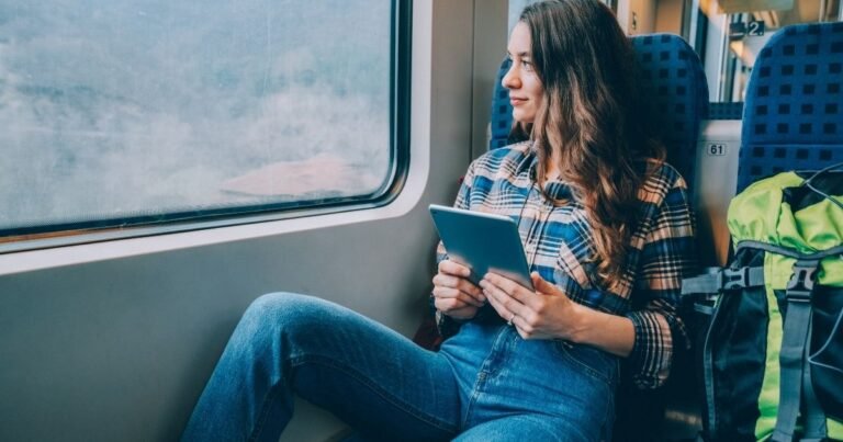 A first time solo traveler sitting inside the plan with his check list on her hand spiring through the window