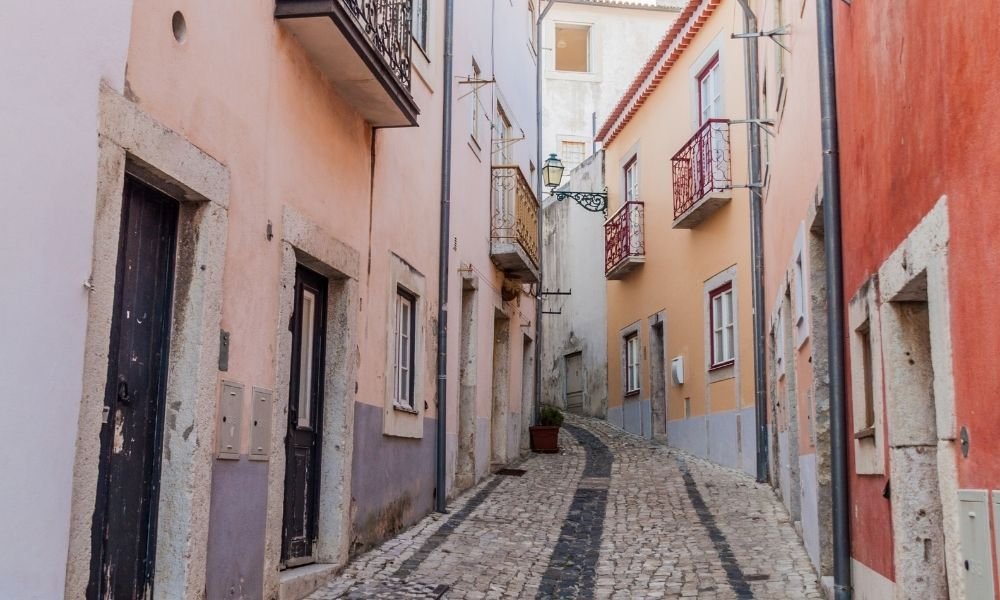 Narrow side street in Alfama with tiled facades, Lisbon
