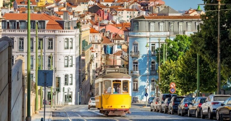 Tram 28 climbing through Alfama, Lisbon Suggested shot: the tram mid-climb on a narrow Alfama street, ideally with rooftops visible.