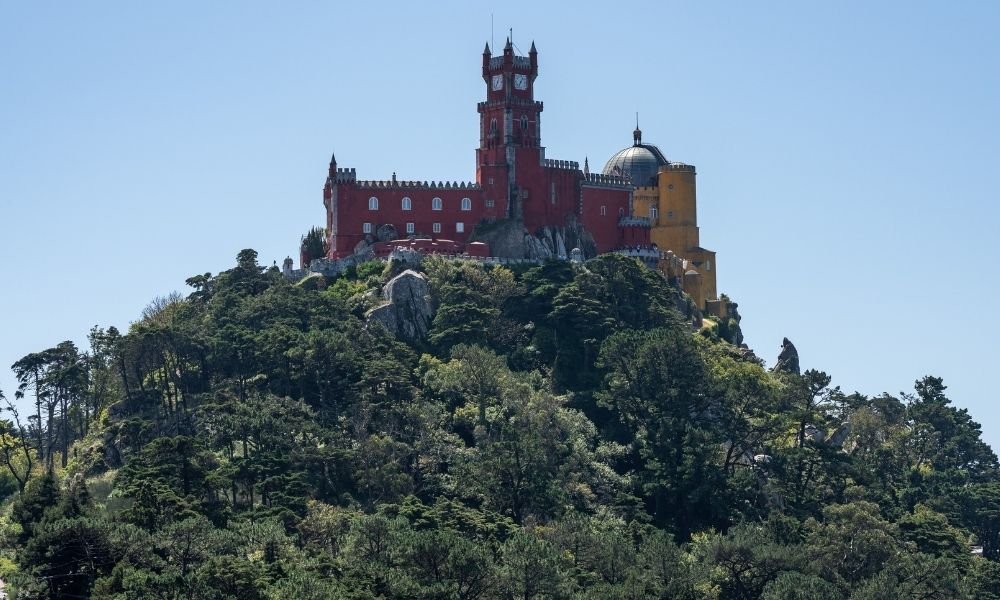 Pena Palace Sintra Portugal perched on hilltop surrounded by forest