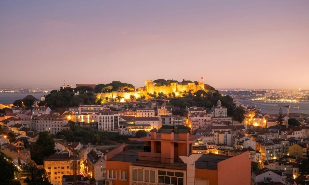 View from São Jorge Castle ramparts over Alfama rooftops and the Tagus river, Lisbon