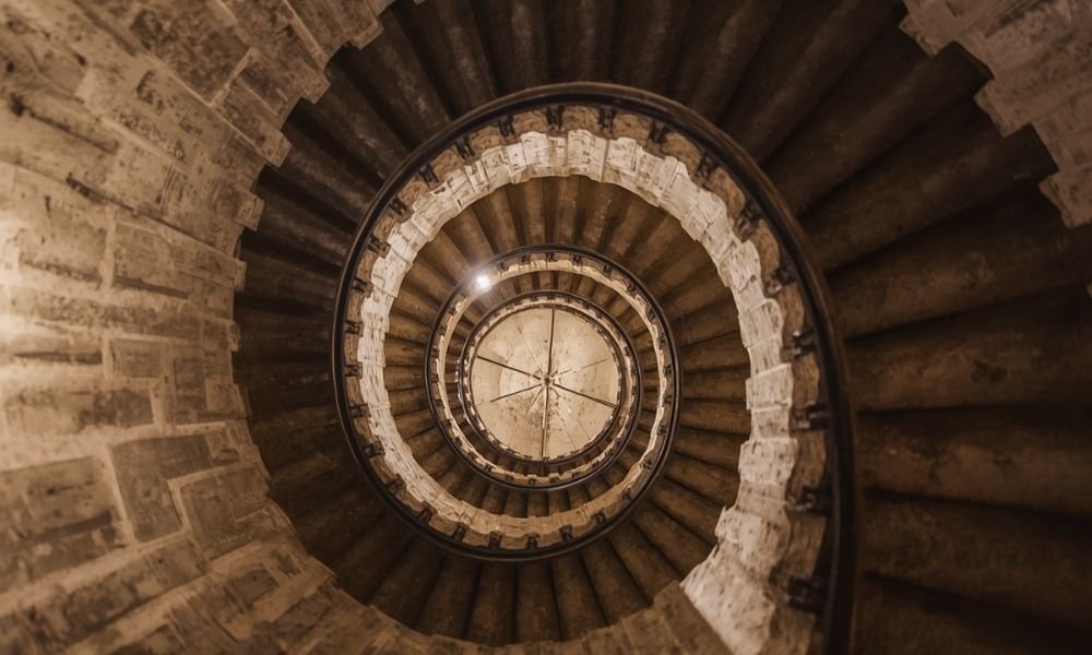 `Narrow spiral staircase inside Belém Tower leading to the upper floors`