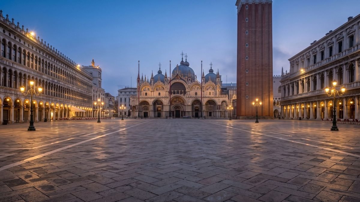 `Empty Piazza San Marco and the Byzantine facade of Saint Mark's Basilica at dawn in Venice Italy`